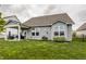 Charming home featuring a covered patio, manicured lawn, and professional landscaping at 14878 Anees Ln, Fishers, IN 46040