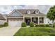 Charming brick home with a well-manicured lawn, covered entry, and a two-car garage at 14878 Anees Ln, Fishers, IN 46040