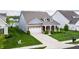 Charming home with a manicured lawn, attached garage, and a brick and siding exterior at 14878 Anees Ln, Fishers, IN 46040
