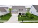 Beautiful home featuring a brick facade, dormer windows, and well-manicured landscaping at 14878 Anees Ln, Fishers, IN 46040