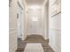 Bright and airy hallway with hardwood floors and elegant white wainscoting at 14878 Anees Ln, Fishers, IN 46040