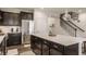 Open-concept kitchen featuring a large island with seating, stainless steel appliances, and modern lighting at 14878 Anees Ln, Fishers, IN 46040