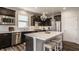 Stylish kitchen with stainless steel appliances, dark cabinetry, quartz countertops, and a large island at 14878 Anees Ln, Fishers, IN 46040