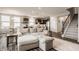 Open-concept living room showcases a modern kitchen, dining area, and staircase, creating a seamless flow at 14878 Anees Ln, Fishers, IN 46040