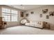 Spacious living room features large windows and neutral carpeting for a bright and inviting atmosphere at 14878 Anees Ln, Fishers, IN 46040