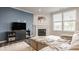 Comfortable living room featuring a fireplace, large windows, and a cozy couch for relaxation at 14878 Anees Ln, Fishers, IN 46040