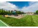 A community playground with swings, slides, and climbing features near the community pool at 14878 Anees Ln, Fishers, IN 46040