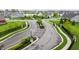 Neighborhood street view showcases a landscaped entrance with elegant stone pillars and manicured greenery at 14878 Anees Ln, Fishers, IN 46040