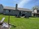 Spacious backyard includes a well-maintained lawn and planting beds along the rear of the house at 1502 Austin Dr, Lebanon, IN 46052