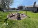 Landscaped backyard with inviting fire pit and seating area, perfect for outdoor entertaining at 1502 Austin Dr, Lebanon, IN 46052