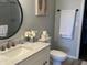 Bathroom vanity with marble countertops, modern fixtures, oval mirror and open to closet creating a functional space at 1502 Austin Dr, Lebanon, IN 46052