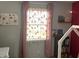 Bedroom with light pink walls, decorative curtains, and a window for natural light at 1502 Austin Dr, Lebanon, IN 46052