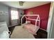 Stylish bedroom features a bed frame, an accent wall, and modern decor at 1502 Austin Dr, Lebanon, IN 46052