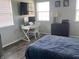 Comfortable bedroom with a blue duvet, a white desk and two windows at 1502 Austin Dr, Lebanon, IN 46052