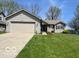Charming single-story home with a well-maintained lawn and attached two-car garage at 1502 Austin Dr, Lebanon, IN 46052
