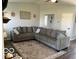 Open living room design with a large gray couch, decorative rug, artwork on the walls and open doorway at 1502 Austin Dr, Lebanon, IN 46052