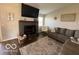 Comfortable living room features fireplace with decor, neutral paint, and large grey sectional at 1502 Austin Dr, Lebanon, IN 46052