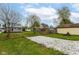 Spacious backyard with gravel path, multiple storage buildings, and verdant grassy areas at 1523 S K St, Elwood, IN 46036