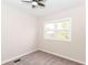 Bedroom featuring soft carpet flooring, a ceiling fan, and a window at 1523 S K St, Elwood, IN 46036