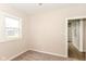 Bedroom with carpet flooring, a window, and attached closet with built-in storage at 1523 S K St, Elwood, IN 46036