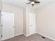 Bedroom featuring carpet, neutral paint, ceiling fan, and two entry doors at 1523 S K St, Elwood, IN 46036