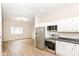 Open concept kitchen with stainless steel appliances connects to the bright and airy living area at 1523 S K St, Elwood, IN 46036