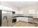 Modern kitchen featuring stainless steel appliances, white cabinets, and a built-in desk area at 1523 S K St, Elwood, IN 46036