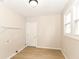 Well-lit laundry room featuring wood-look floors and window offering natural light at 1523 S K St, Elwood, IN 46036