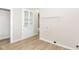 Bright laundry area with built-in storage, neutral walls, and wood-look flooring at 1523 S K St, Elwood, IN 46036