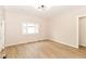 Neutral living room with wood floors and white trim offers natural light and modern lighting at 1523 S K St, Elwood, IN 46036