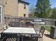 The backyard's outdoor dining area features multiple grills and a dining table, all set against a wooden fence backdrop at 15406 Destination Dr, Noblesville, IN 46060