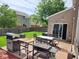 Backyard with patio area featuring grill, table and chairs, and lush green lawn, for outdoor dining at 15406 Destination Dr, Noblesville, IN 46060