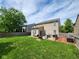 Expansive backyard with a well-maintained lawn, patio, and fenced perimeter, offering ample space at 15406 Destination Dr, Noblesville, IN 46060