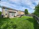 Spacious backyard with a lush lawn, patio area, and wooden fence, ideal for Gathering gatherings at 15406 Destination Dr, Noblesville, IN 46060