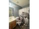 Rustic bathroom with a oak vanity and a novelty shower curtain and toilet seat at 15406 Destination Dr, Noblesville, IN 46060