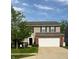 Charming two-story home with a well-maintained lawn and a spacious two-car garage at 15406 Destination Dr, Noblesville, IN 46060