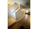 View of the carpeted stairs and wood flooring leading to the living room at 15406 Destination Dr, Noblesville, IN 46060