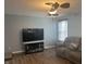 Inviting living room with comfortable seating, wood floors, ceiling fan and large screen television at 15406 Destination Dr, Noblesville, IN 46060
