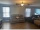 Spacious living room with durable wood floors, comfortable seating, ceiling fan and neutral colors at 15406 Destination Dr, Noblesville, IN 46060