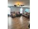 Living room showcasing wood floors and natural light from windows at 15406 Destination Dr, Noblesville, IN 46060