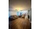 Open-concept living room with stylish wood flooring and a view into the kitchen at 15406 Destination Dr, Noblesville, IN 46060