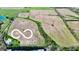 Aerial view of land showing open fields and trees, with a house in the distance at 1630 N 400 W, Bargersville, IN 46106