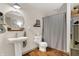 Clean and simple bathroom with a pedestal sink, framed round mirror, and linen closet at 1630 N 400 W, Bargersville, IN 46106