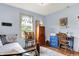 Bright bedroom with blue accent wall, window with sheer curtains, wooden desk and dollhouse at 1630 N 400 W, Bargersville, IN 46106