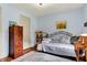 Bright bedroom with wooden floors, area rug, metal bed frame, and wooden dressers at 1630 N 400 W, Bargersville, IN 46106