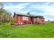 Side view of the red home showing well-kept lawn and landscaping at 1630 N 400 W, Bargersville, IN 46106