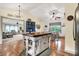Open floor plan showcasing kitchen with large island, chandelier and eat-in area with natural light at 1630 N 400 W, Bargersville, IN 46106