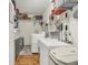 Bright laundry room with storage, white appliances, sink, and wood-look flooring at 1630 N 400 W, Bargersville, IN 46106