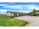 Exterior view of the outbuilding with multiple garage doors and a gravel driveway at 1630 N 400 W, Bargersville, IN 46106