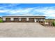 Exterior view of the outbuilding with multiple garage doors and a gravel driveway at 1630 N 400 W, Bargersville, IN 46106
